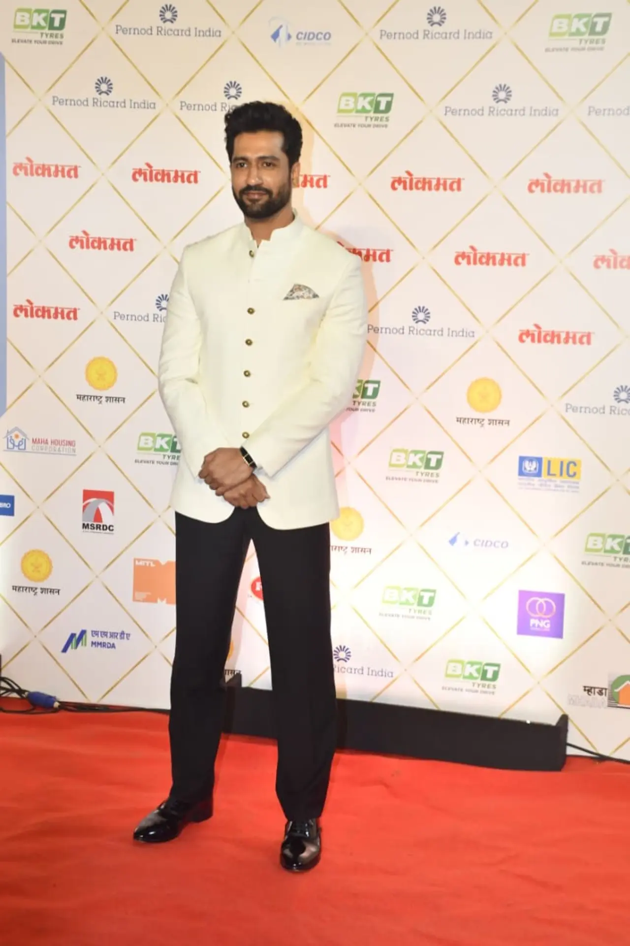 Vicky Kaushal looked dapper as he paired a crisp white structured jacket-style top with sleek black pants.